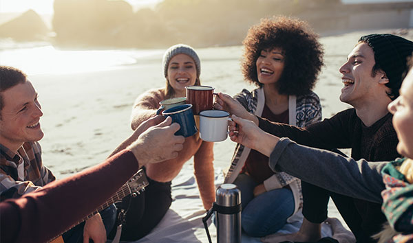 group of people around a lake drinking coffee