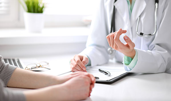 Physician and patient sitting talking